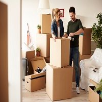 couple-packing-stuff-among-plenty-cardboard-boxes